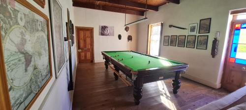 a hallway with a pool table in a room at Whipstock Guest Farm in McGregor