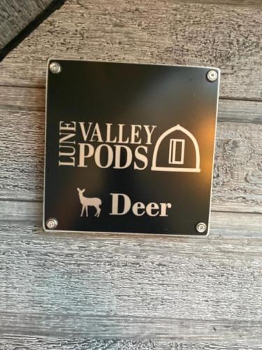 a sign for a valley rods deer on a wall at Glamping Pods in Milngavie