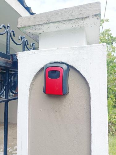 a red and black object on the side of a wall at De'Manda Homestay in Sandakan