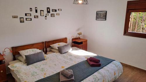 a bedroom with a bed with two pillows on it at Casa Champasak in Órgiva