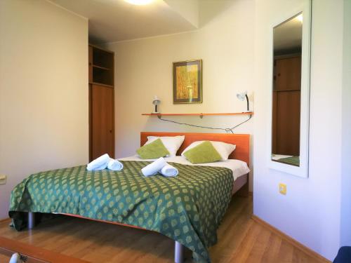a bedroom with a bed with towels on it at Apartments Bilic with garden & swimming pool - 50m from the beach in Pješčana Uvala 