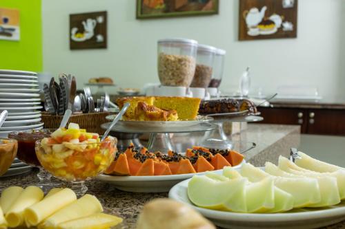 a table topped with plates of food on a counter at Hotel Lisbor in Francisco Beltrão