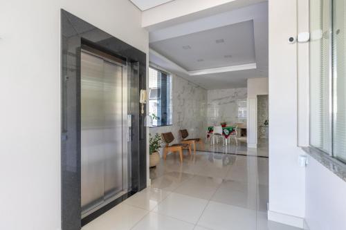 a hallway with a glass door in a building at Hotel Lisbor in Francisco Beltrão