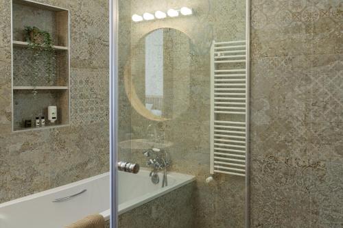 a bathroom with a shower with a sink and a mirror at Hotel Rural Ohana in Santa Cruz de Tenerife