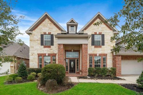 a large brick house with a front yard at Houston House~Sleeps 16~Arcade Style Game Room in Deer Park
