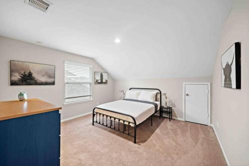 a bedroom with a bed and a desk in it at Houston House~Sleeps 16~Arcade Style Game Room in Deer Park