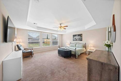 a large living room with a bed and a kitchen at Houston House~Sleeps 16~Arcade Style Game Room in Deer Park