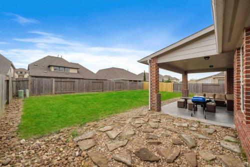 a backyard with a patio and a fence at Houston House~Sleeps 16~Arcade Style Game Room in Deer Park