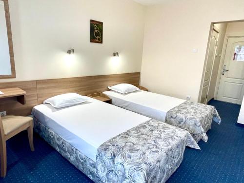 a hotel room with two beds and a table at BSA Gradina Hotel & Aquapark - All Inclusive in Golden Sands