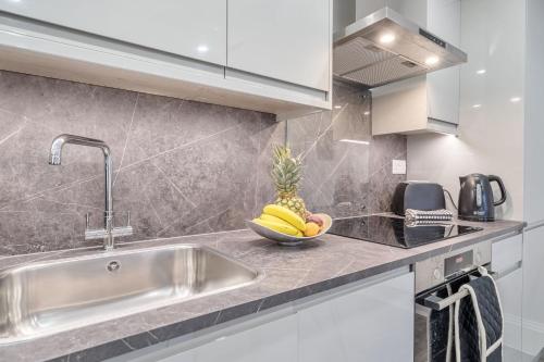 a kitchen with a sink and a bowl of bananas at Boutique Living by Lawsons in Windsor