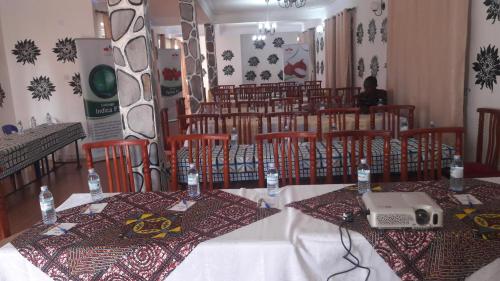 a dining room with a table with a laptop on it at Kigezi Gardens Inn in Kabale