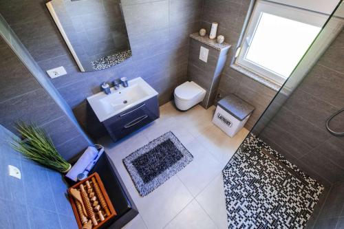 an overhead view of a bathroom with a sink and a toilet at Villa Enna with heated pool, Zadar in Crno