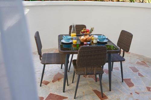 a table and chairs with a meal on a patio at Résidence Carlton - Rénovée avec Piscine in Beaulieu-sur-Mer