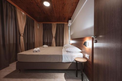 a bedroom with a bed and a wooden ceiling at Stella's Holiday Resort in Tigaki