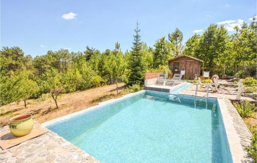 a swimming pool in a yard with a house at Awesome Home In Bordezac With Outdoor Swimming Pool in Bordezac