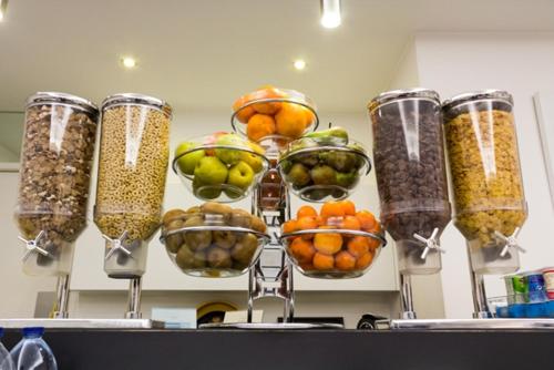 a bunch of bowls filled with fruits and vegetables at Hotel Laranjeira in Viana do Castelo