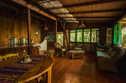 a living room with a table and chairs at Ocean Forest Ecolodge in San Pedrillo