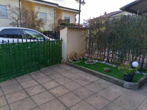 a fence with a yard with a little grass at La villetta 2.0 in Rende