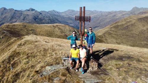 a group of people standing around a cross on a mountain at Frühstückspension Lemberger in Dellach im Drautal