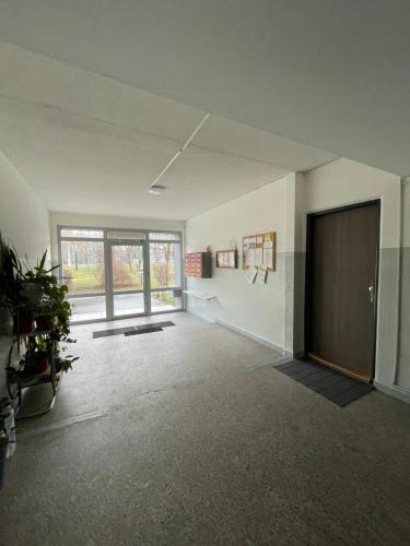 an empty room with a door and a window at Cozy Self check-in Apartment in vibrant Ruzinov area, Komárnická 42, Bratislava in Bratislava