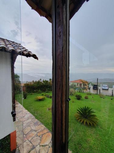 a view of a yard from a window of a house at Nosso Chalet in Lavras Novas