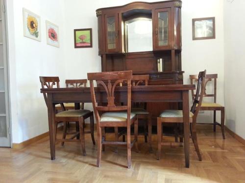 a wooden dining room table with chairs and a mirror at WI-FI Clima Molfetta 26 in Rome