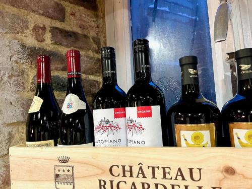 a bunch of wine bottles sitting on a shelf at Le Secret de Mélin in Mélin