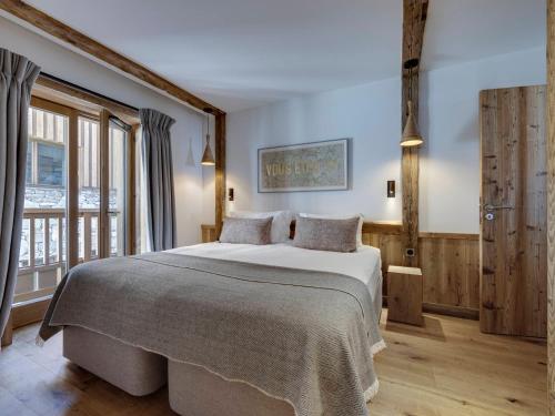 a bedroom with a large bed and a large window at Appartement Val-d'Isère, 4 pièces, 6 personnes - FR-1-694-40 in Val-d'Isère