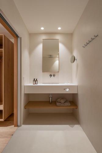 a bathroom with a sink and a mirror at Posthotel Lechtal, Arlberg in Holzgau