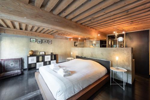 a bedroom with a large white bed and a table at LE SOYEUX - T3 calme avec terrasse à la Croix Rousse in Lyon