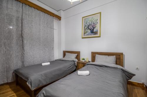 two beds sitting next to each other in a room at Studio Mélange in Loutraki DT in Loutraki