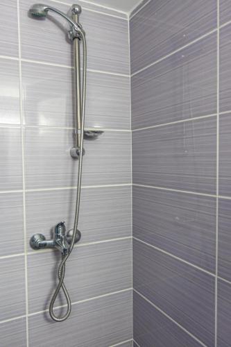a shower with a shower head in a bathroom at Studio Mélange in Loutraki DT in Loutraki