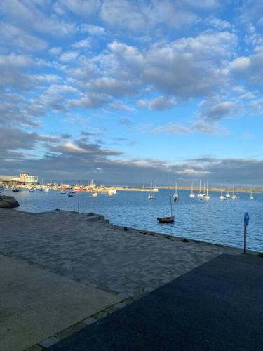 a view of a harbor with boats in the water at Charmant petit appartement les pieds dans l'eau in Douarnenez