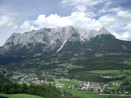 a view of a mountain range with a town at Pointhäusl in Pfarrwerfen