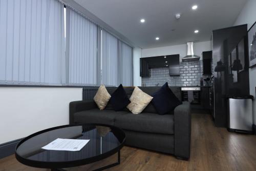 a living room with a couch and a table at New Oxford House Apartments By Happy Days in Liverpool
