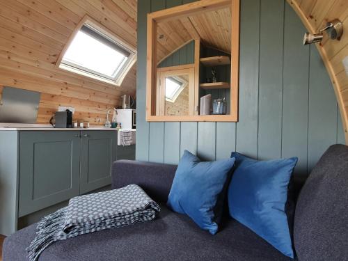 a living room with a couch in a tiny house at Odli Glamping - Luxury Glamping Pod in Welshpool