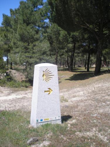 a sign in a field with trees in the background at El Molino in Nieva