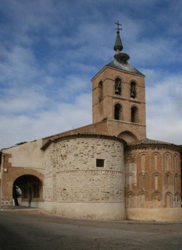 a church with a tower with a cross on top at El Molino in Nieva