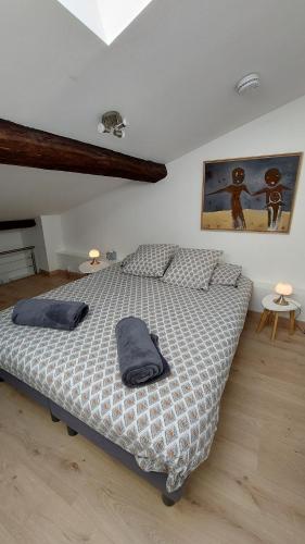 a bedroom with a bed with two pillows on it at Appart face au mail in Limoges