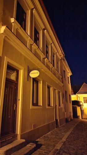 a building with a door on a street at night at Penzion HARMONIE in Trhové Sviny