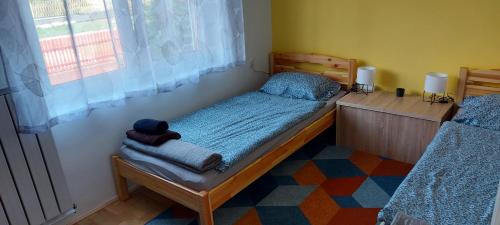 a bedroom with a bed with a teddy bear on it at Zsófi apartman in Fonyód
