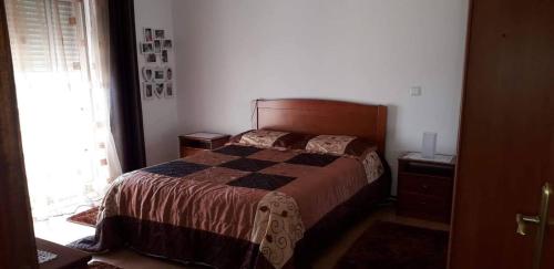 a bedroom with a bed with a checkered blanket at Casa da Cândida in Nazaré