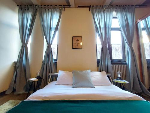 a bedroom with a bed with blue drapes at Sweet Dreams Suites Piata Romana in Bucharest