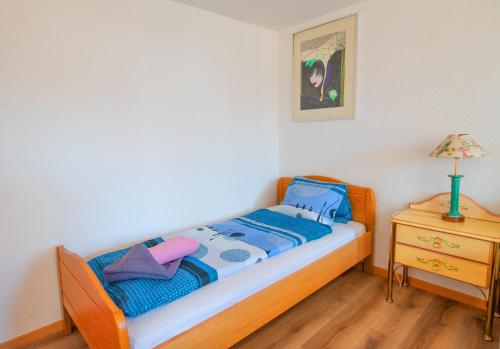 a small bedroom with a bed and a night stand at Residence Jungfrau in Interlaken