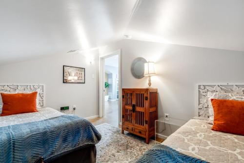 a bedroom with two beds and a mirror at Walk Score 90!!-Historic Downtown District-2 Blocks to Famous Forsyth Park- Huge Private Patio-Private Parking in Savannah