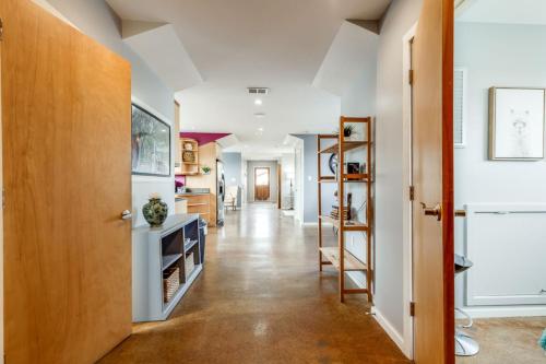 a hallway of a home with white walls and a wooden door at Walk Score 90!!-Historic Downtown District-2 Blocks to Famous Forsyth Park-FREE Private Parking-Huge Private Patio in Savannah