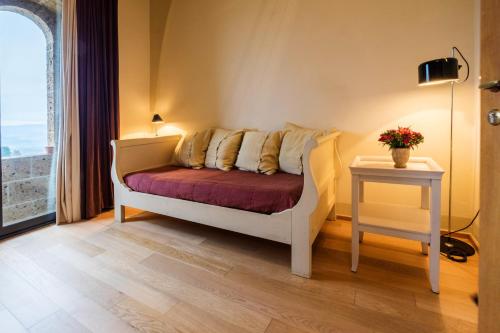 a room with a couch and a table and a window at Locanda Palazzone in Orvieto
