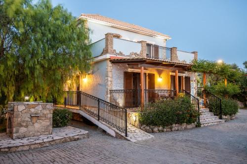 a house with a staircase in front of it at Olive Tree Villas in Kipseli