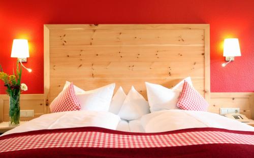 a bedroom with a large bed with white pillows at Rebstock Waldulm in Kappelrodeck