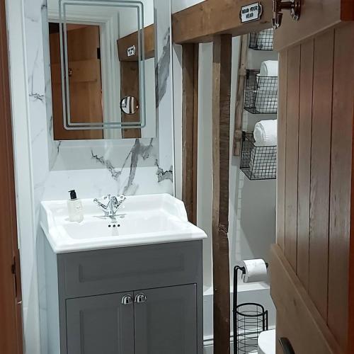 a bathroom with a sink and a mirror at B&Bat no3 in Market Bosworth